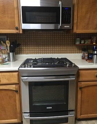 Gourmet dual fuel double oven with convection microwave above