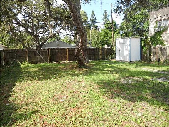 Large fenced in back yard with access to alley