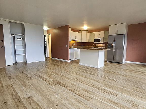 Hardwood, vinyl floors throughout! Spacious living room, dining space and Kitchen. Office Table in window area.