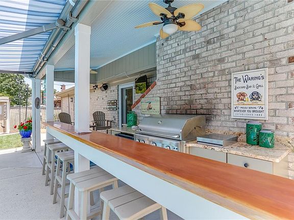 Bar With Bar Stools That Convey, Turn On Ceiling Fans For Tropical Ambience