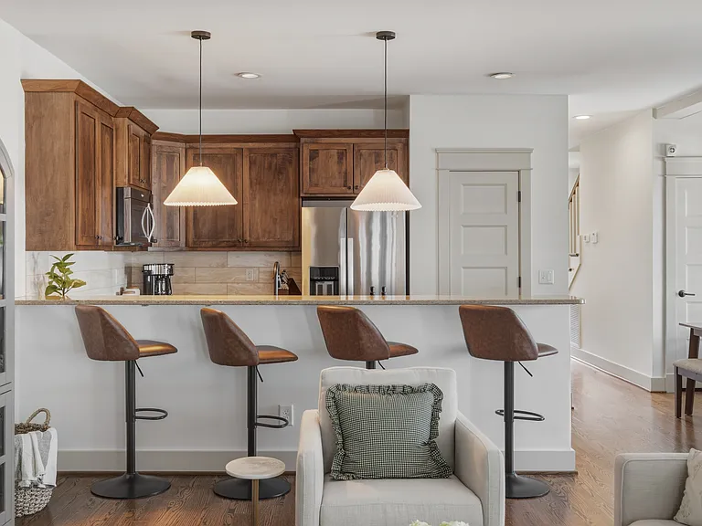 Fully equipped kitchen with stainless steel appliances. Bar countertop includes seating for 4.