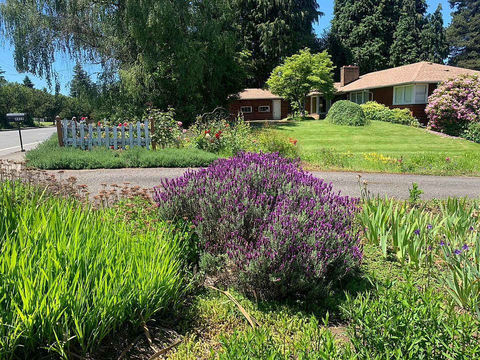 Beatifully maintained ranch house with redwood siding, pictureiaue picket fencing expansive lawns and gardens, off street half circle driveway, mature trees provide shade and privacy.