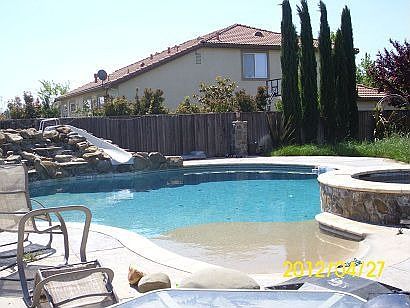 beach-like entry w/ water slide