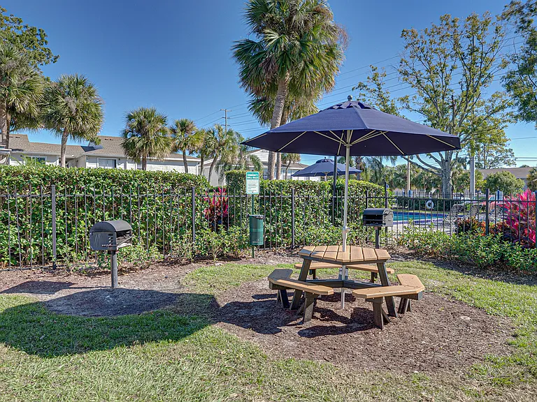 Outdoor grilling and picnic area with shaded seating