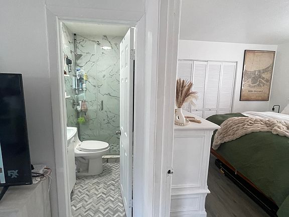 Restroom is located outside Master bedroom and connects with open living layout.