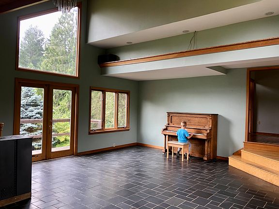 Living room with Slate Floor. Stairs lead to dining room
