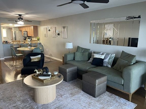 Furnished Living Room off Dining Area open to the deck view of water.