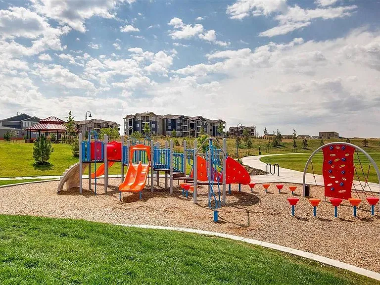 View of one of the playgrounds and walking trails that wind throughout the community.