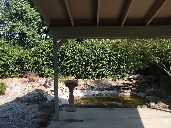 Covered patio with a koi pond