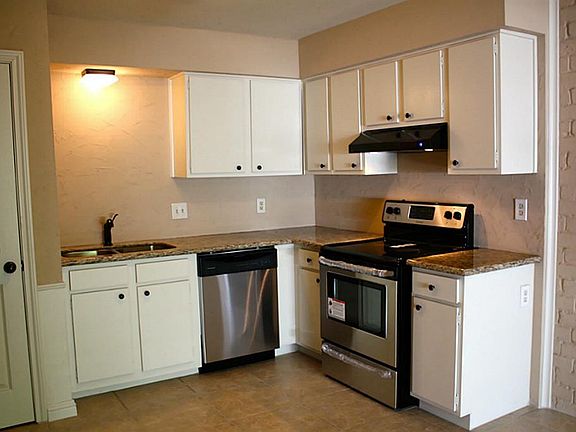 View of the recently  renovated kitchen.  Granite counter tops, stainless steel appliances, under mount stainless steel sink, hood.