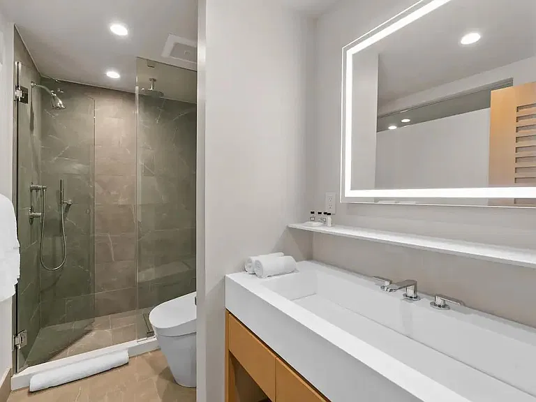 High end finishings include a glass framed shower with a Graff rain shower