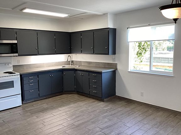 Kitchen with microwave, refrigerator and oven.