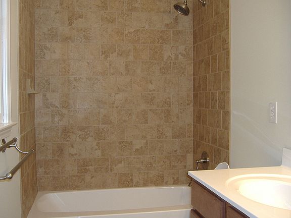 Master Bathroom with beautiful tile surrounded shower and rainfall showerhead.