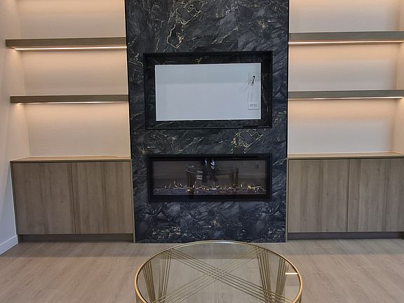 TV wall with electric fireplace, shelves with LED lights and storage cabinet
