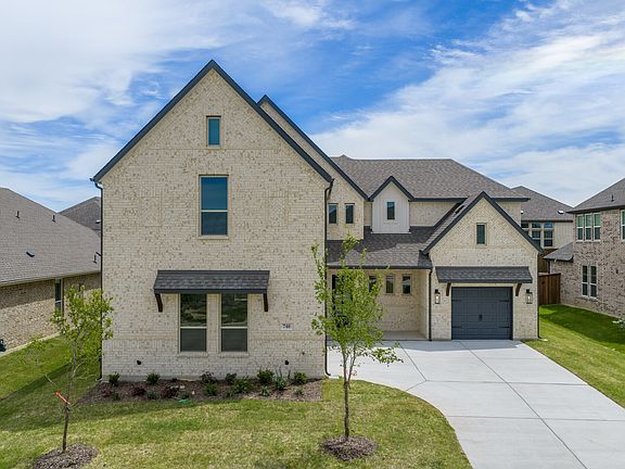 Exterior of modern tudor style home by Kindred Homes