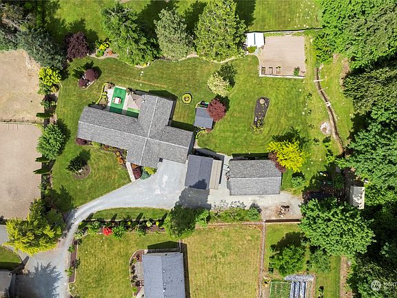 The aerial view shows the expanse of land, trees & lush garden & landscape areas. The carports, garages and workshops provide tons of parking, storage & space for your work and leisure>