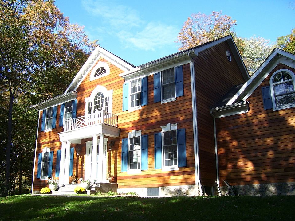Sunny hilltop, surrounded by tall trees.