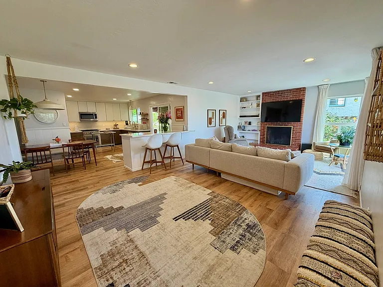 Indoor/ outdoor living. Woodburning fireplace, large slider to front deck, slider from kitchen to back side patio and yard