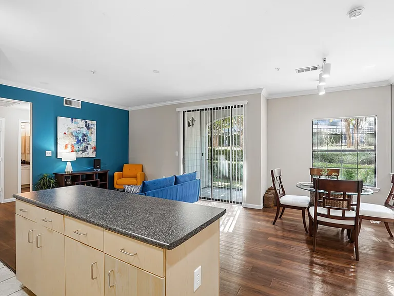 Large livingspace with large dining window and sliding pation door to create an open and bright space