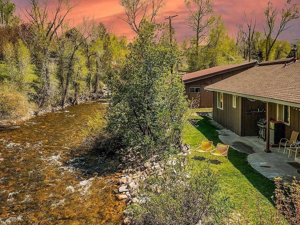 Side entrance of workshop/garage space can be seen in the back of the photo, detached from home.