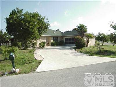Long driveway entrance and side load garage.