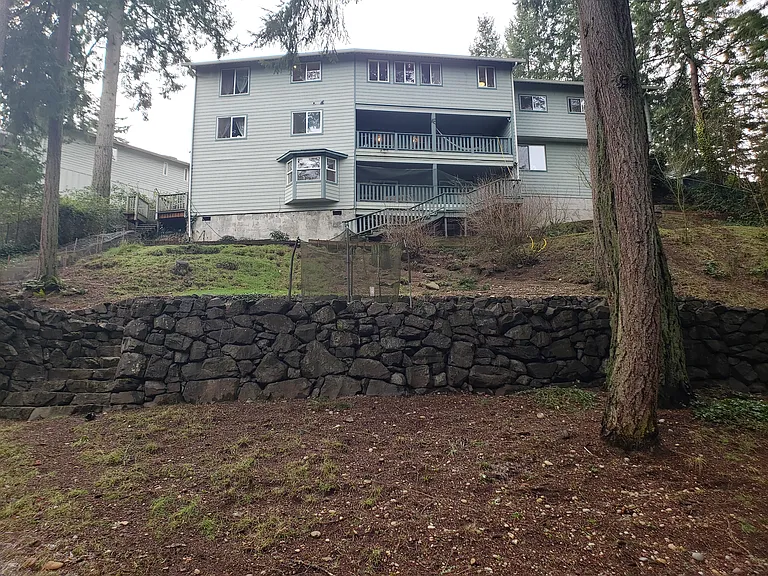 view from base of back yard looking up to the three story house.