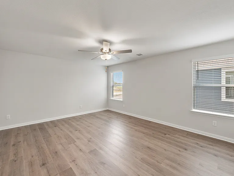 The master bedroom is spacious and has two wonderful windows.