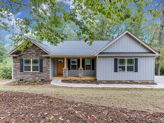 Craftsman style w/stacked stone cedar columns and stacked stone gable. side-entry garage.