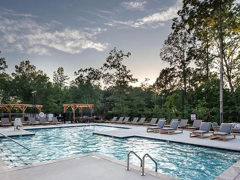 Luxury Outdoor Pool Area with Sun Deck, Cabanas, and Ample Seating