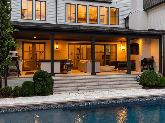 Enjoy your morning cup of coffee or watch an evening movie with the family on the covered patio. Includes an outdoor kitchen, grill, dining and lounge area.