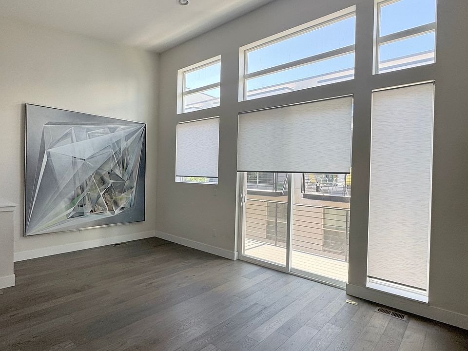 High vaulted ceilings with large windows in living room