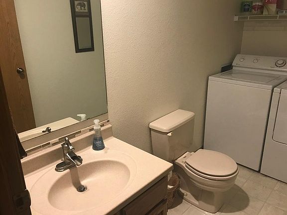 1/2 bath at the base of the stairway near front door. New Maytag washing machine (as of 7/30/24) and dryer.