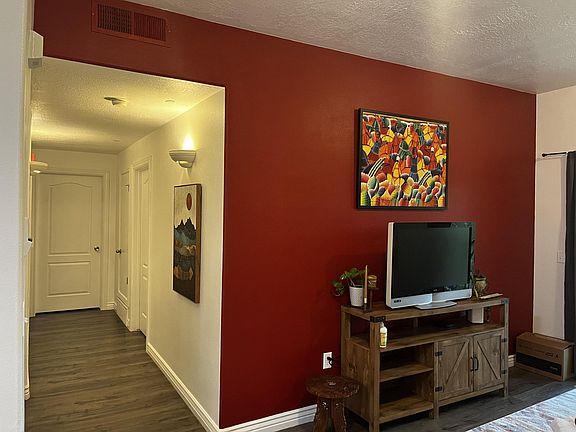 Living room wall and entrance to hallway with bedrooms