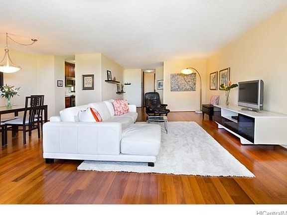 View of the living room with dining area and kitchen on the left.