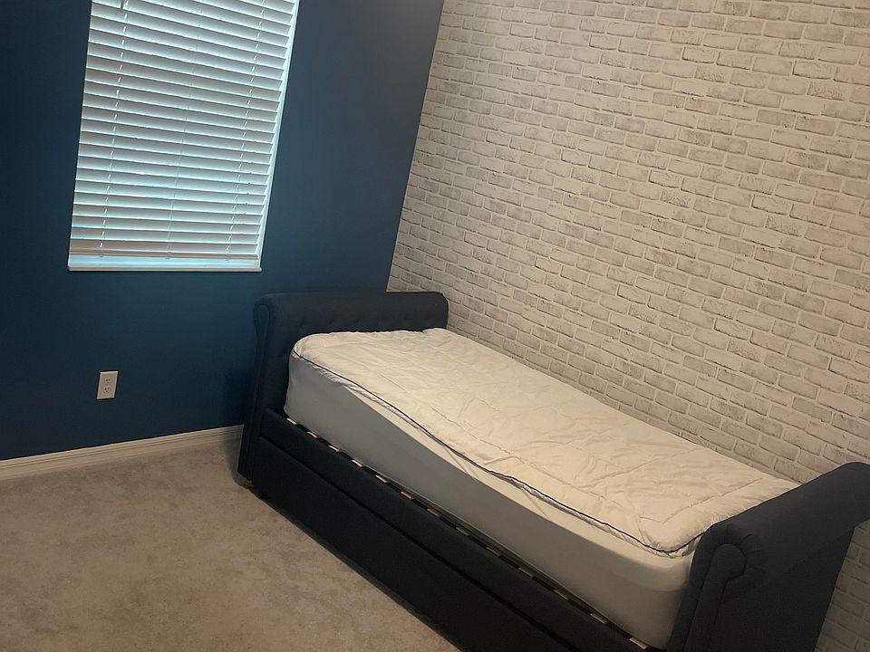This is the space available for rent. It's currently blue but can be painted any color you like. Can come furnished with a bed and desk or unfurnished if you'd like.
