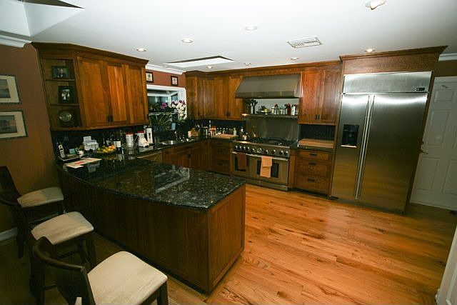 Custom Kitchen Granite with Commercial Stove and GE Monogram Refer & Skylights