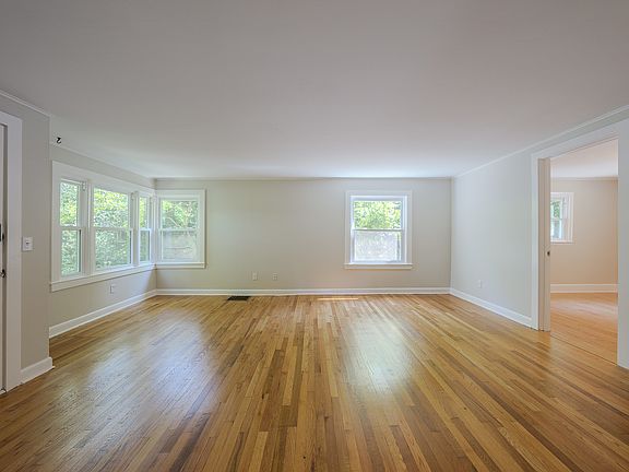 Living Room- Front door to the left, primary bedroom to the right