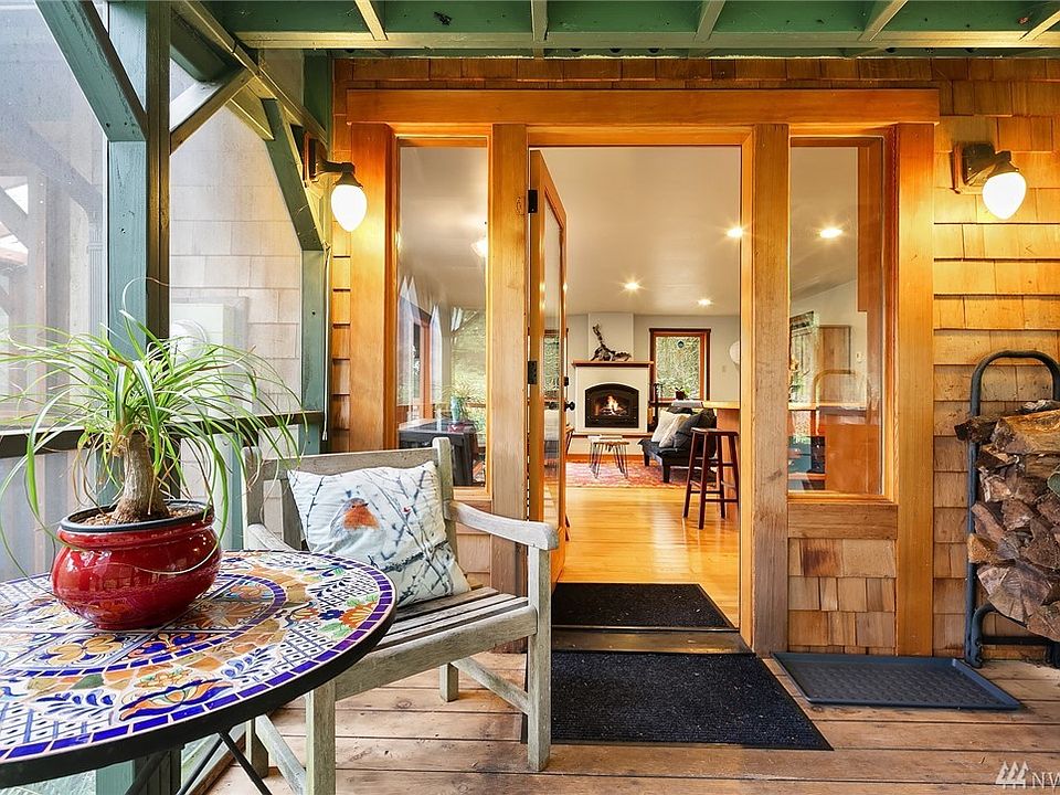 Screened Entry Porch has room for wood storage and a perfect sitting area for early morning coffee or and afternoon wine or tea.