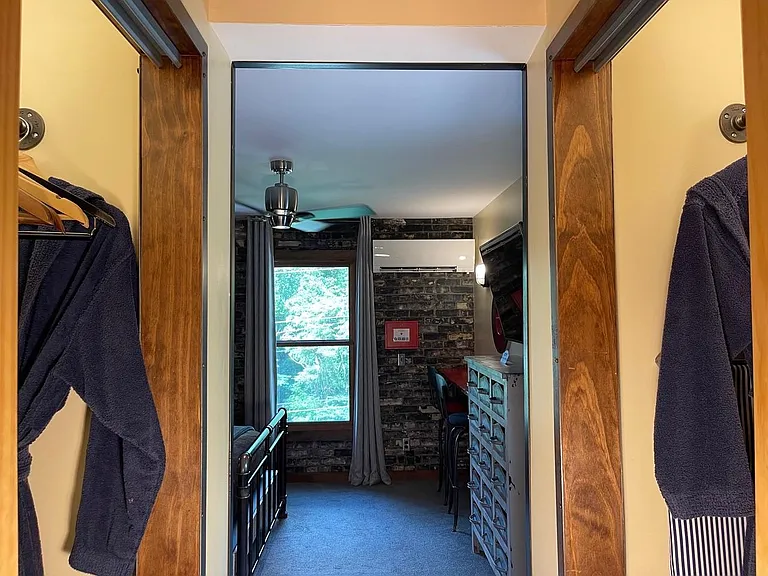 Brickhouse Suite with His & Hers Sliding Door Closets & Built-in Shelving