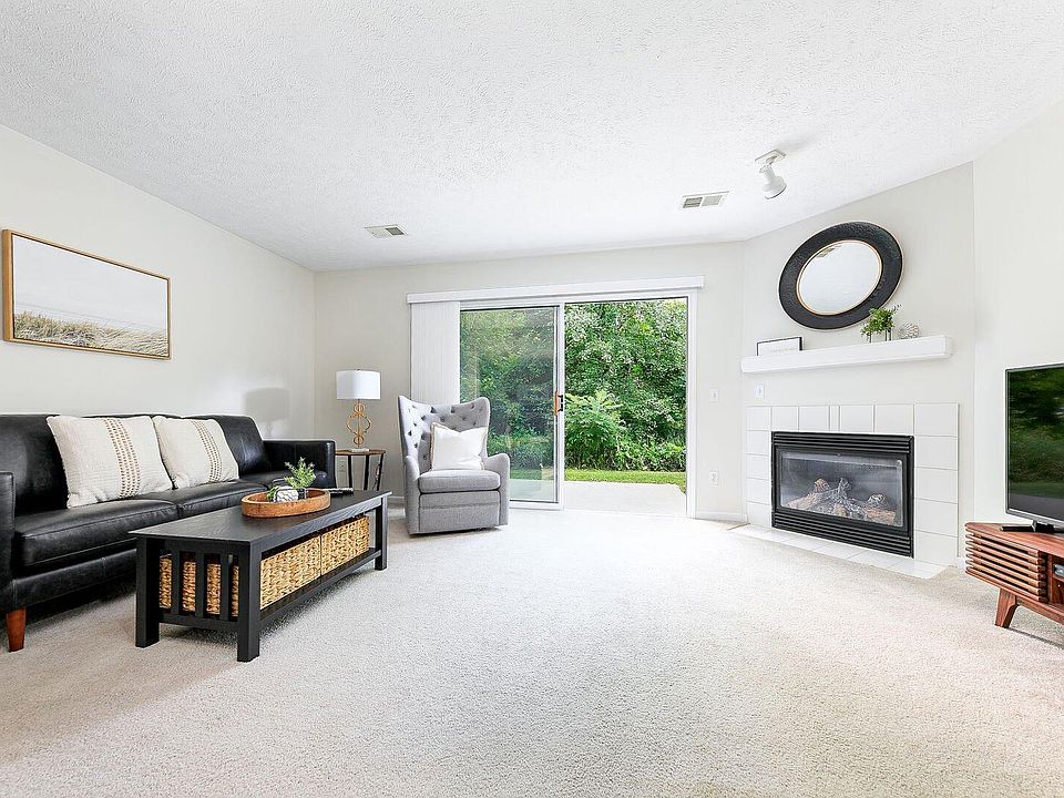 Living Room with 8' Patio Door, Corner Gas Fireplace and Television