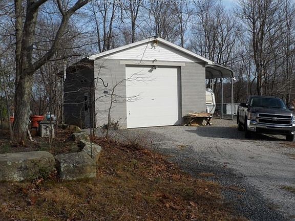 Oversized garage for camper, boat or RV with extra covered parking on side.