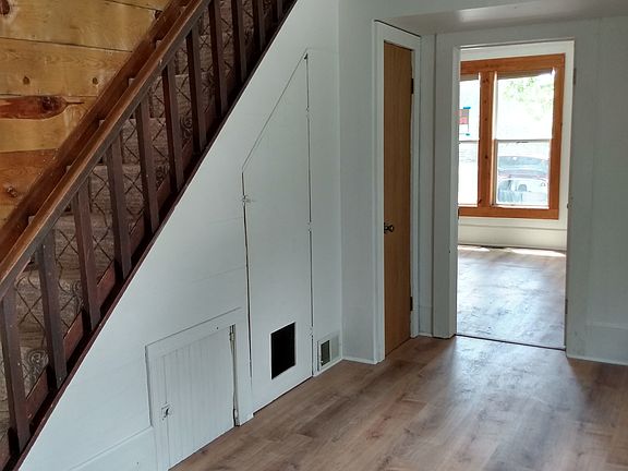 bonus room at bottom of stairs, looking into living room. Stairway goes up to bedrooms.