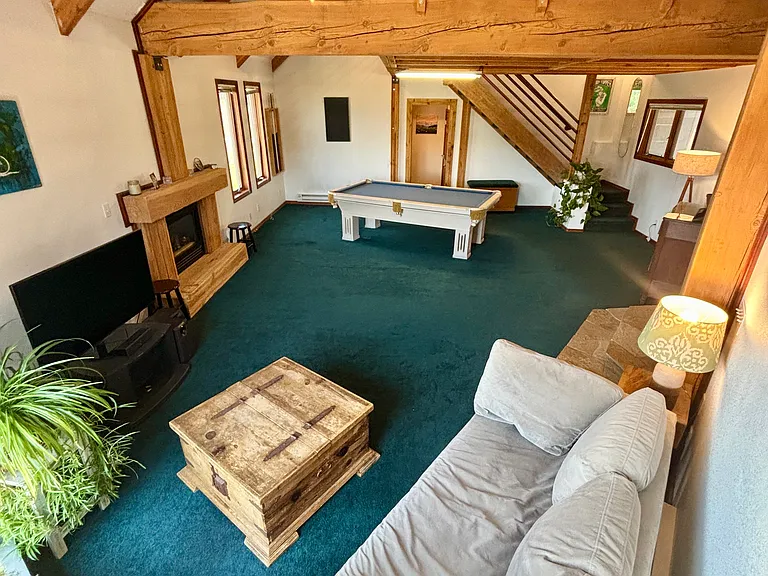 Game room with loft above pool table