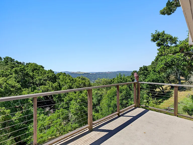 Large deck/view accessible from second bedroom downstairs (pink room)