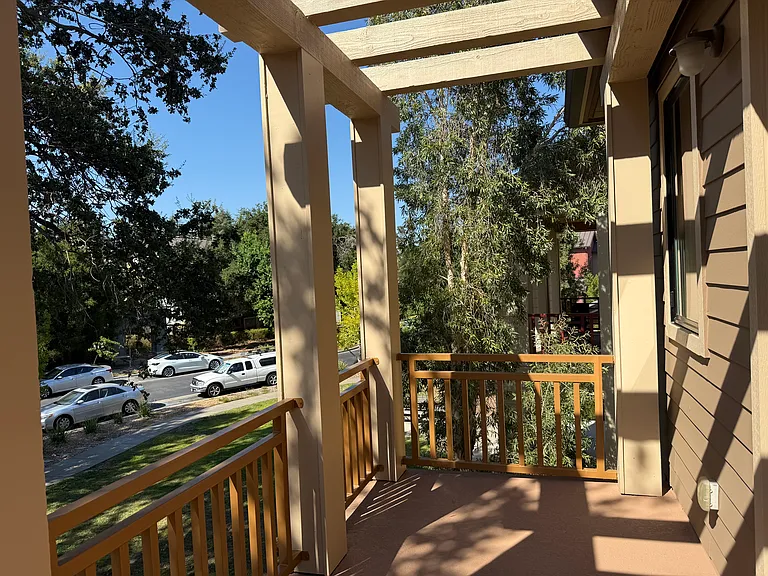 Primary bedroom has a patio door that opens a balcony overlooking the community green belt.