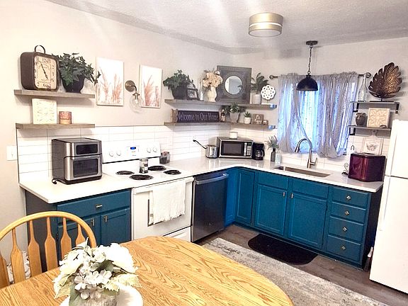 new lighting, quartz countertops, gold accents/faucet, new flooring, new floating shelves, new paint