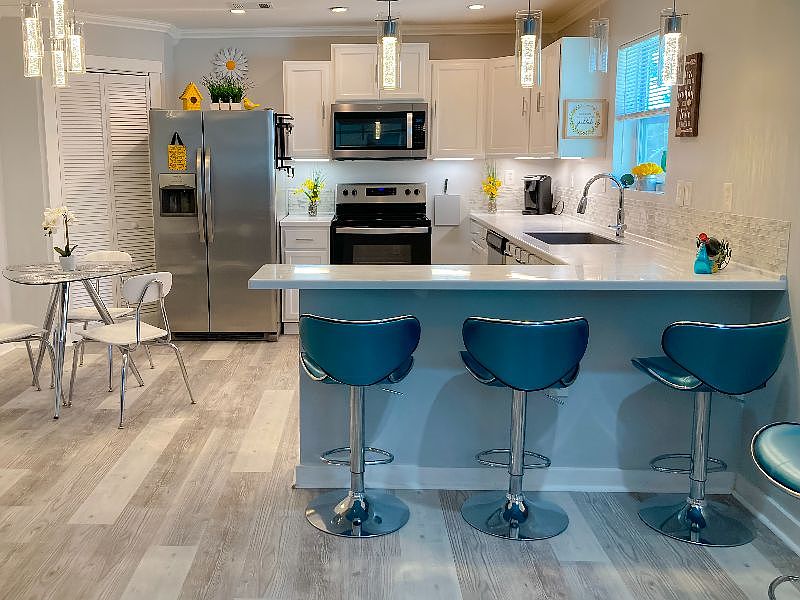 kitchen with bar seating and kitchen table and chairs