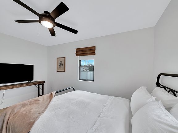 Main floor bedroom with queen bed, closet, TV.