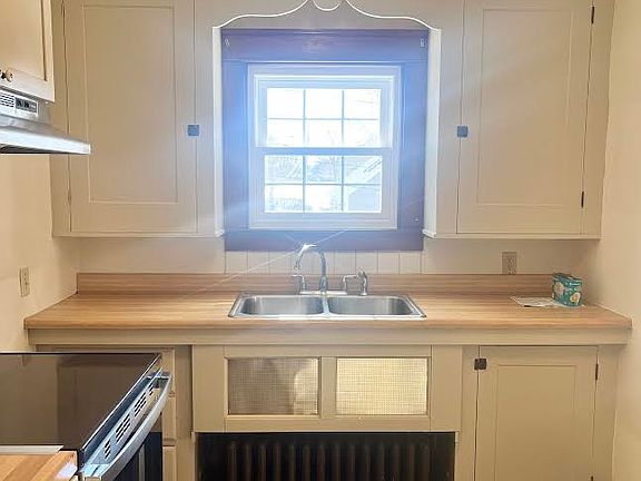 The cutest kitchen! Beautiful cabinetry, soft colors, window over the double sink