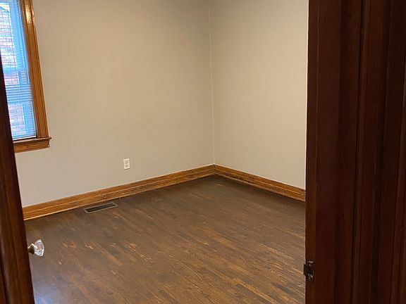 Bedroom with closet, ceiling fan, two windows.